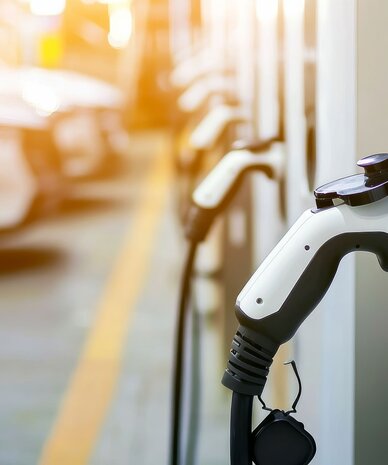 Electric vehicle charging plug connected to a station