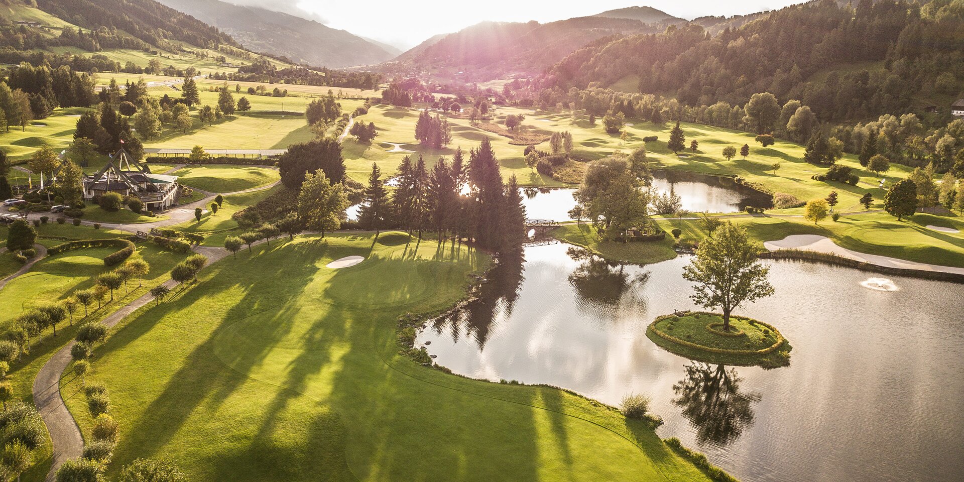 Aerial view of a golf course with ponds and an island