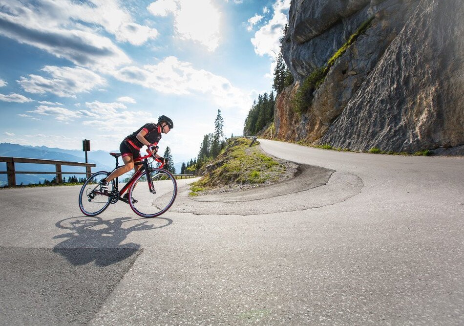 Cyclist riding a road bike on a winding mountain road