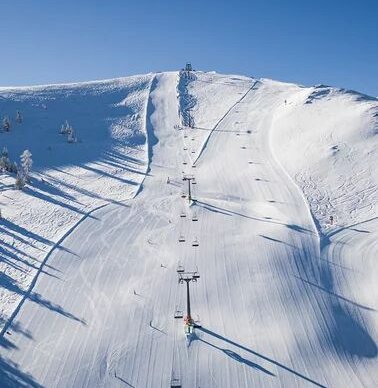 Snow-covered mountain slope with a ski lift