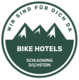 Circular badge showing mountain silhouette and Schladming Dachstein Bike Hotels