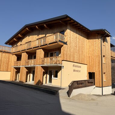 Wooden chalet-style building with multiple balconies