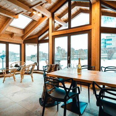 Wooden cabin dining area with expansive windows
