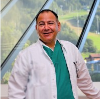 Smiling male doctor in white coat indoors