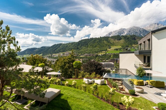 Lawn terrace with loungers, umbrellas, and pool
