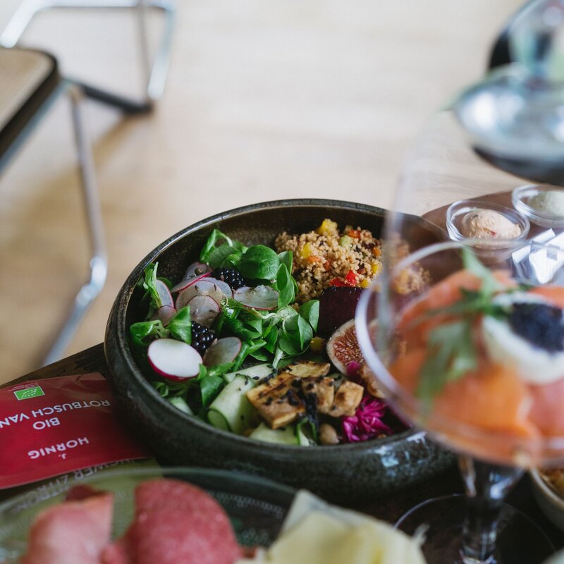 Colorful mixed salad bowl with greens, radishes, and quinoa