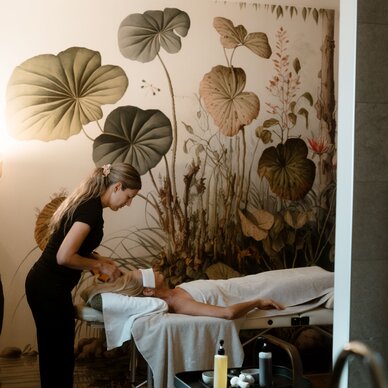 Therapist performs treatment on client lying on massage table