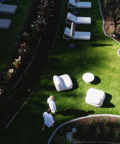 Aerial view of white lounge furniture on green lawn